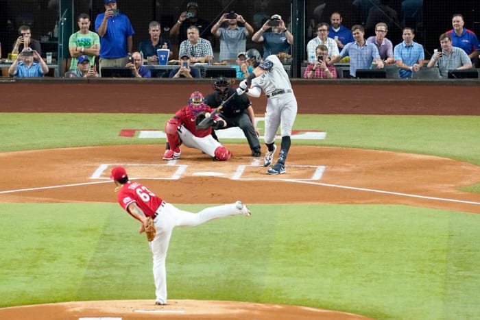 New York Yankees’ Aaron Judge connects for a solo home run, his 62nd of the season, off of Texas Rangers starting pitcher Jesus Tinoco (63) as Texas Rangers catcher Sam Huff and umpire Randy Rosenberg look on in the first inning of the second baseball game of a doubleheader in Arlington, Texas, Tuesday, Oct. 4, 2022. With the home run, Judge set the AL record for home runs in a season, passing Roger Maris.